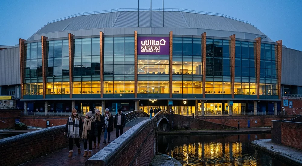 Concert-goers leaving an arena in Birmingham on a winter evening, with a taxi waiting